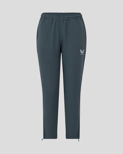 Front view of dark slate Junior Track Pant with drawcord at waist open pockets and Castore logo on the leg