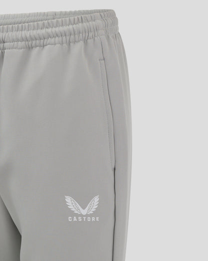 Close-up of grey track pants showing elastic waistband and Castore logo near the hem