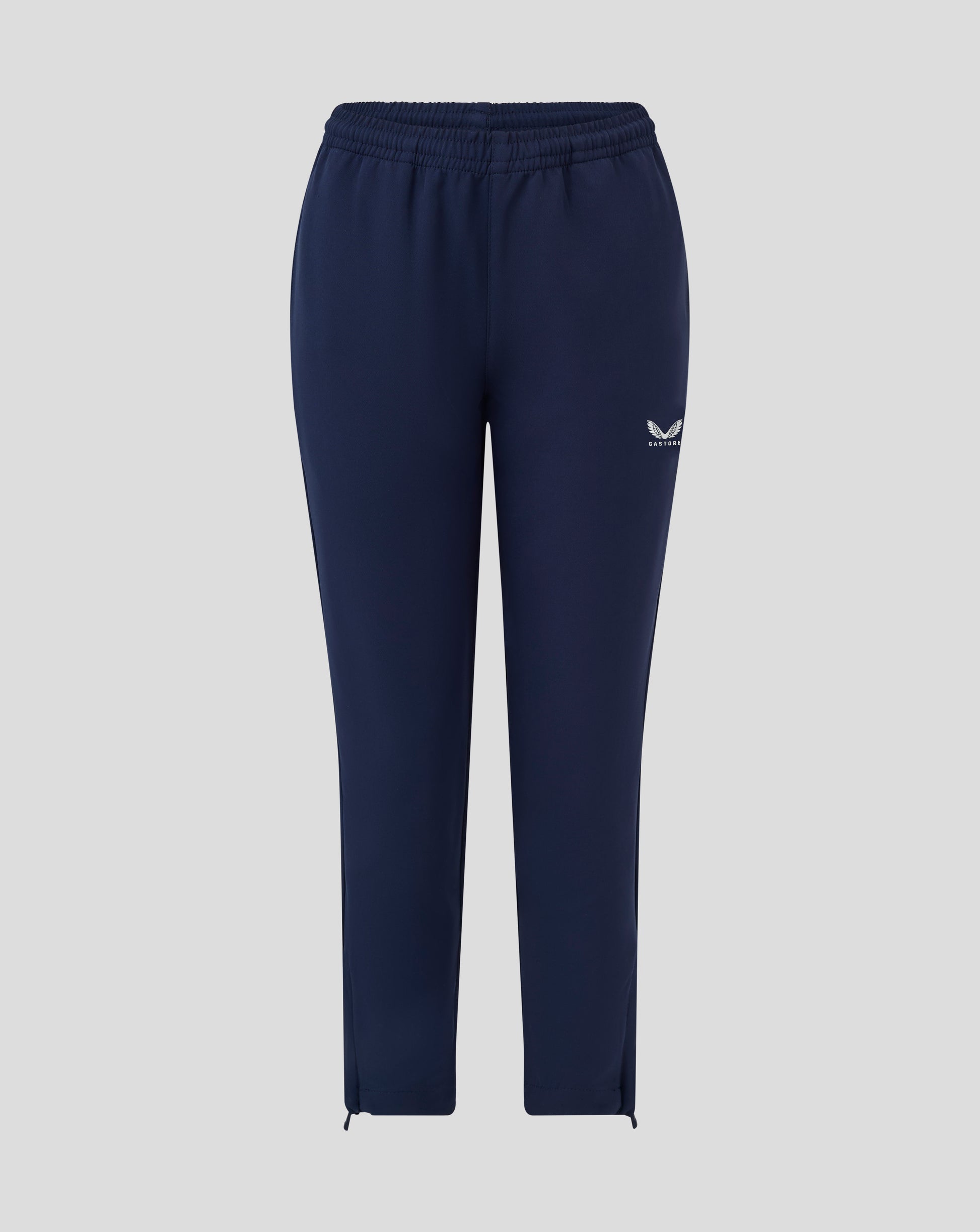 Back view of navy junior track pants with elastic waistband and small Castore logo on the thigh