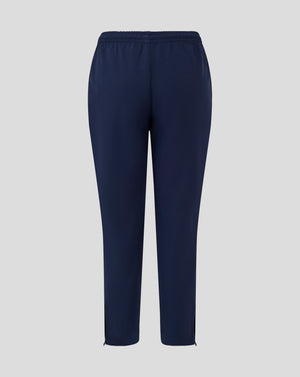 Front view of navy junior track pants with tapered legs and ankle zips