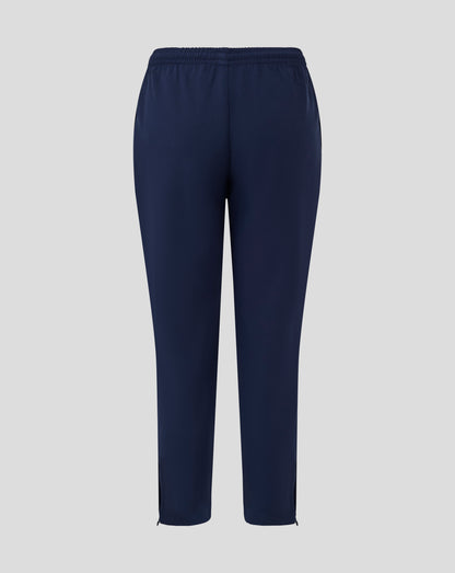 Front view of navy junior track pants with tapered legs and ankle zips