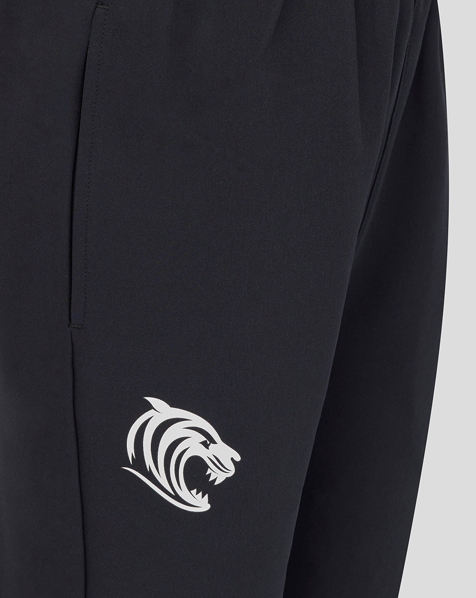 Close up of dark navy track pants showing the white Leicester Tigers crest on the leg
