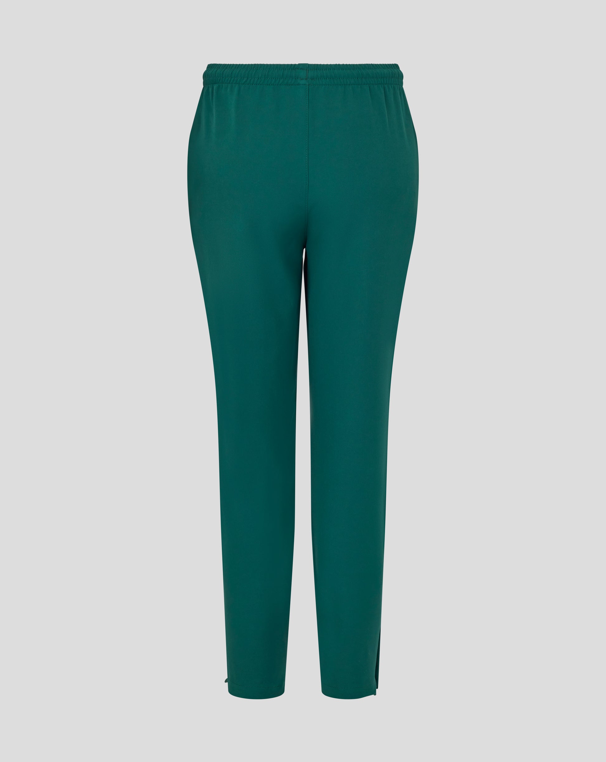 Front view of botanical green junior training track pants with white wing logo on the thigh.