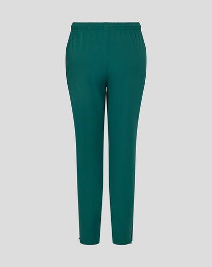 Front view of botanical green junior training track pants with white wing logo on the thigh.