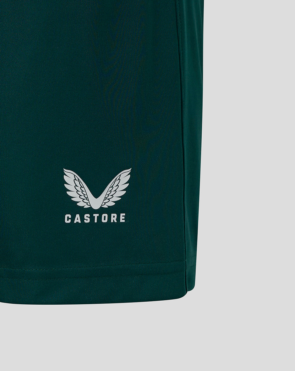 Close up of white Castore wings logo on dark green shorts
