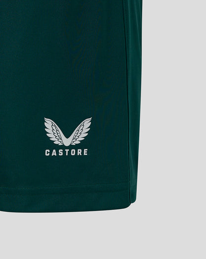 Close up of white Castore wings logo on dark green shorts
