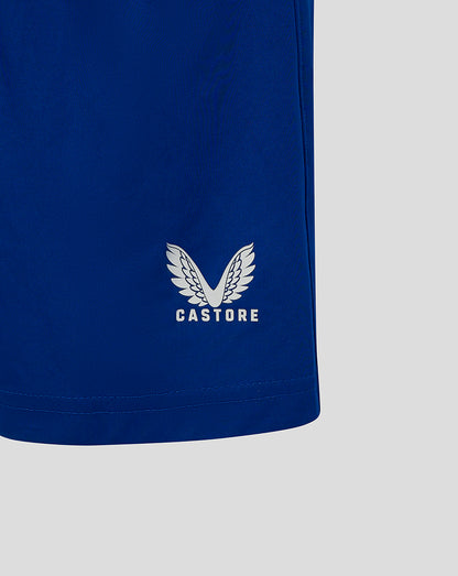 Castore logo on the blue junior match shorts near the hem area
