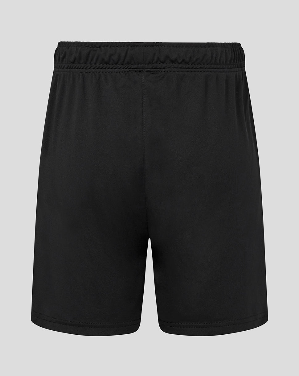 Back view of black junior training shorts with elastic waistband and small white Castore logo on lower leg
