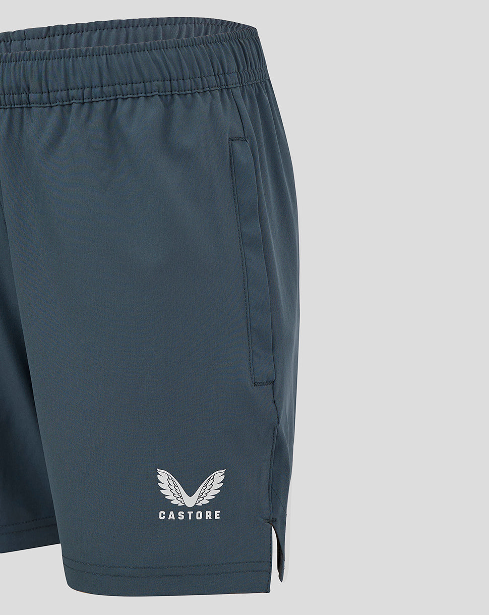 Close up of dark slate woven training shorts showing side pocket and Castore logo near the hem.