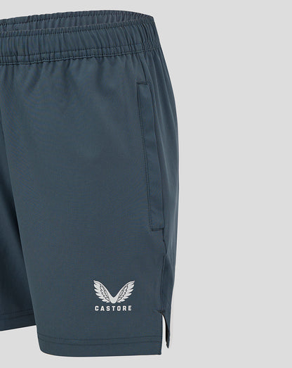Close up of dark slate woven training shorts showing side pocket and Castore logo near the hem.