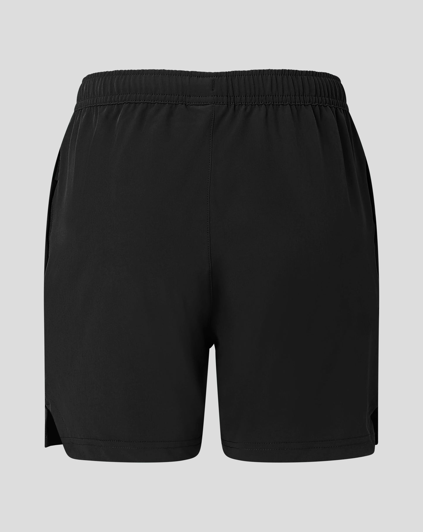 Back view of black junior woven training short with Castore logo near the lower right leg
