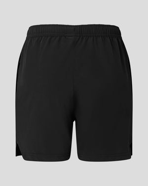 Back view of black junior woven training short with Castore logo near the lower right leg