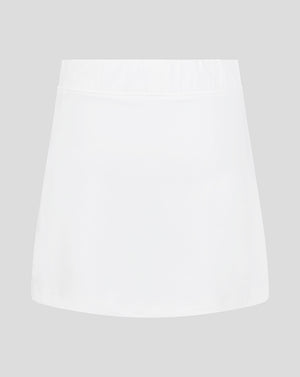 Front view of white junior skort with elasticated waistband and Castore logo at hem