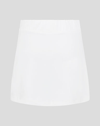 Front view of white junior skort with elasticated waistband and Castore logo at hem