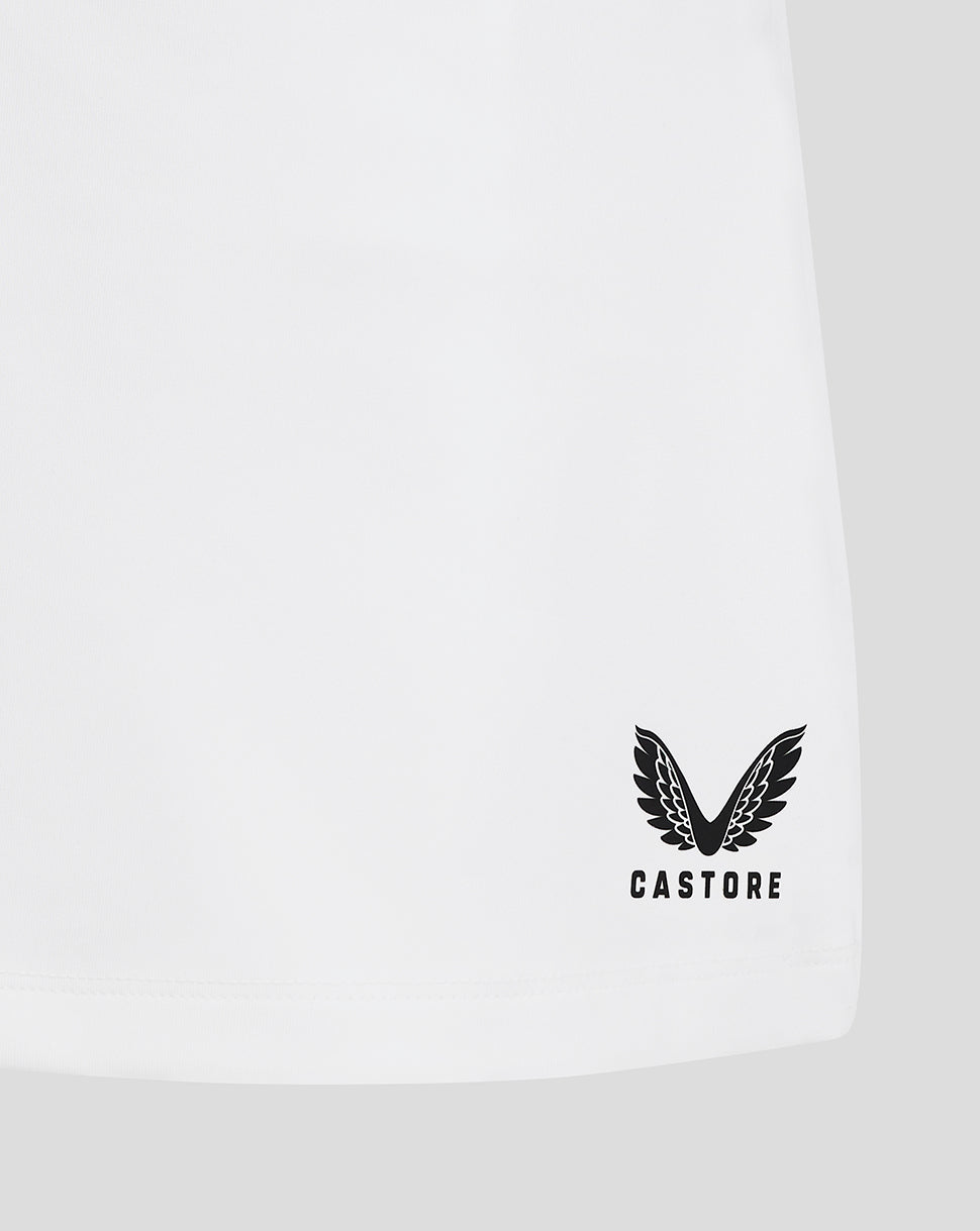 Close up of hem on white junior skort with Castore logo