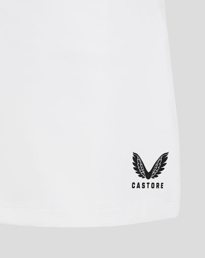 Close up of hem on white junior skort with Castore logo