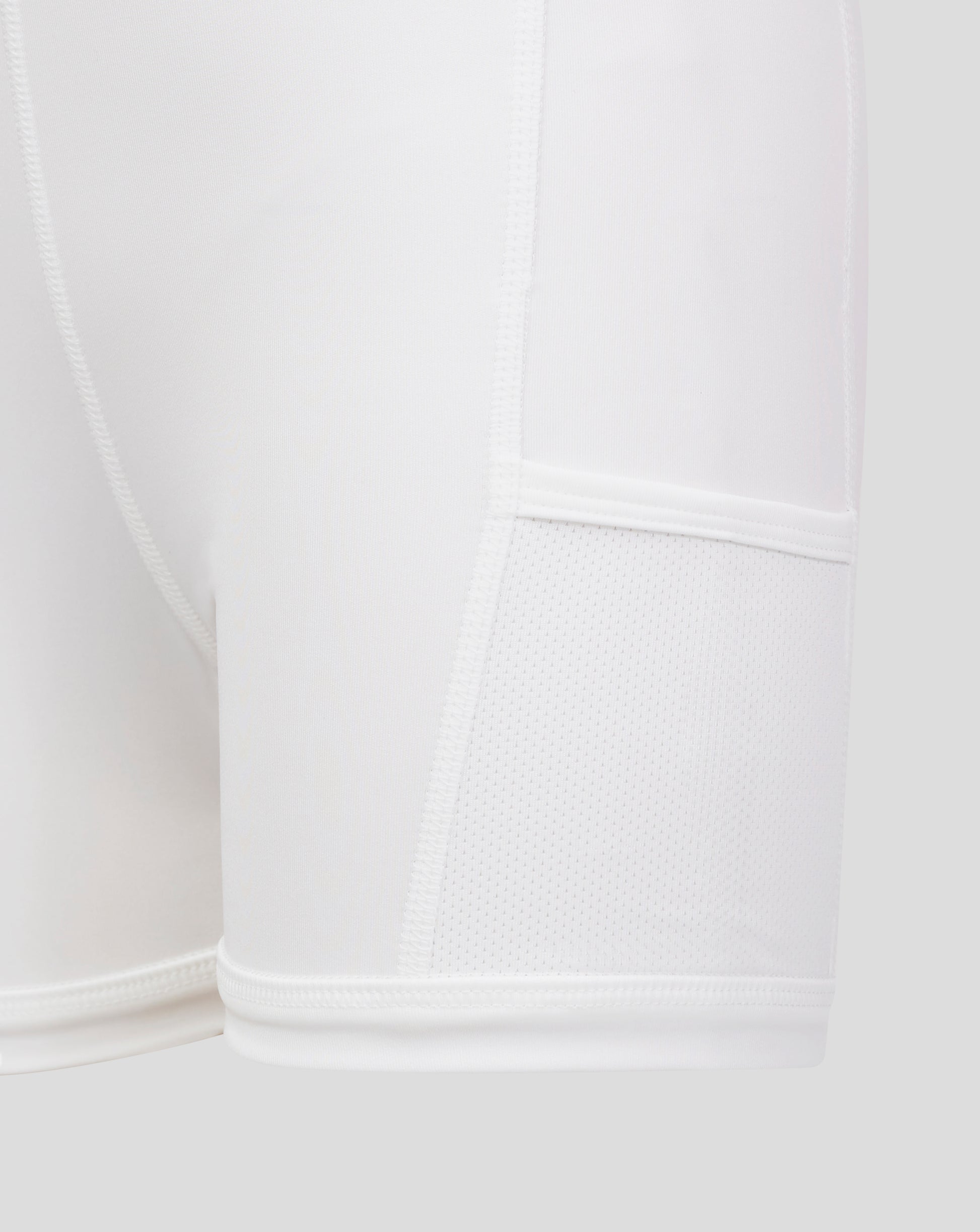 Close up of white Junior Skort fabric showing flat front waistband and inner brief with mesh detail