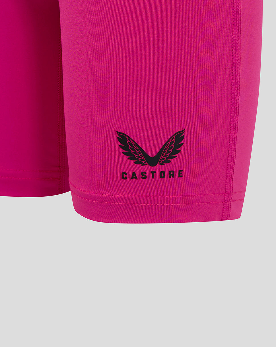 Close-up of Castore logo on lower leg of bright pink Junior Baselayer Short