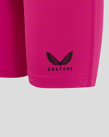 Close-up of Castore logo on lower leg of bright pink Junior Baselayer Short
