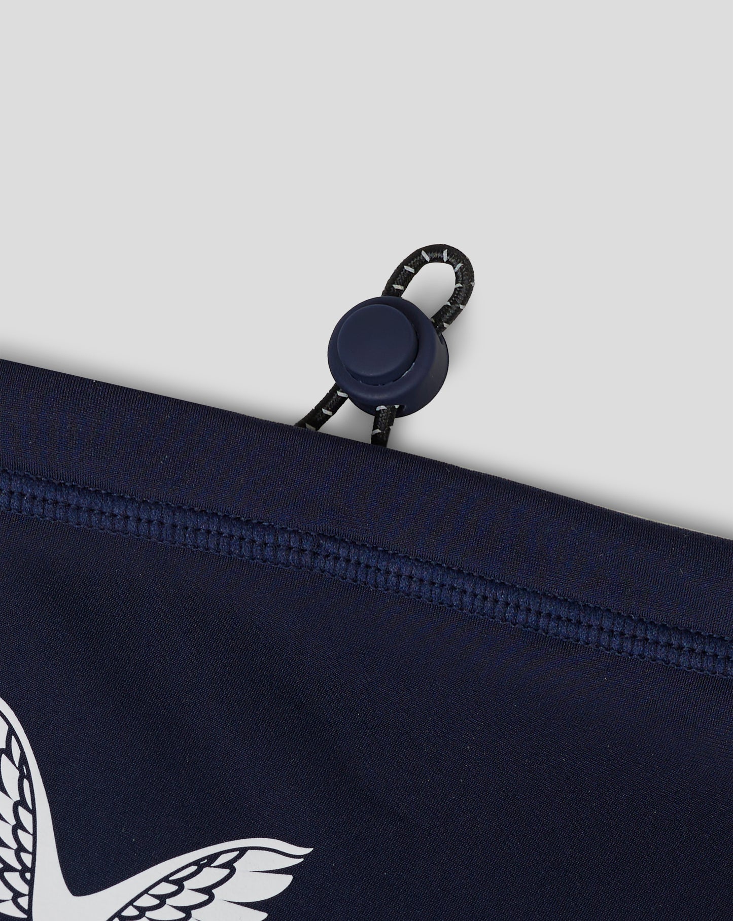 Rear view of navy Junior Performance Snood pouch with drawcord and curved hem