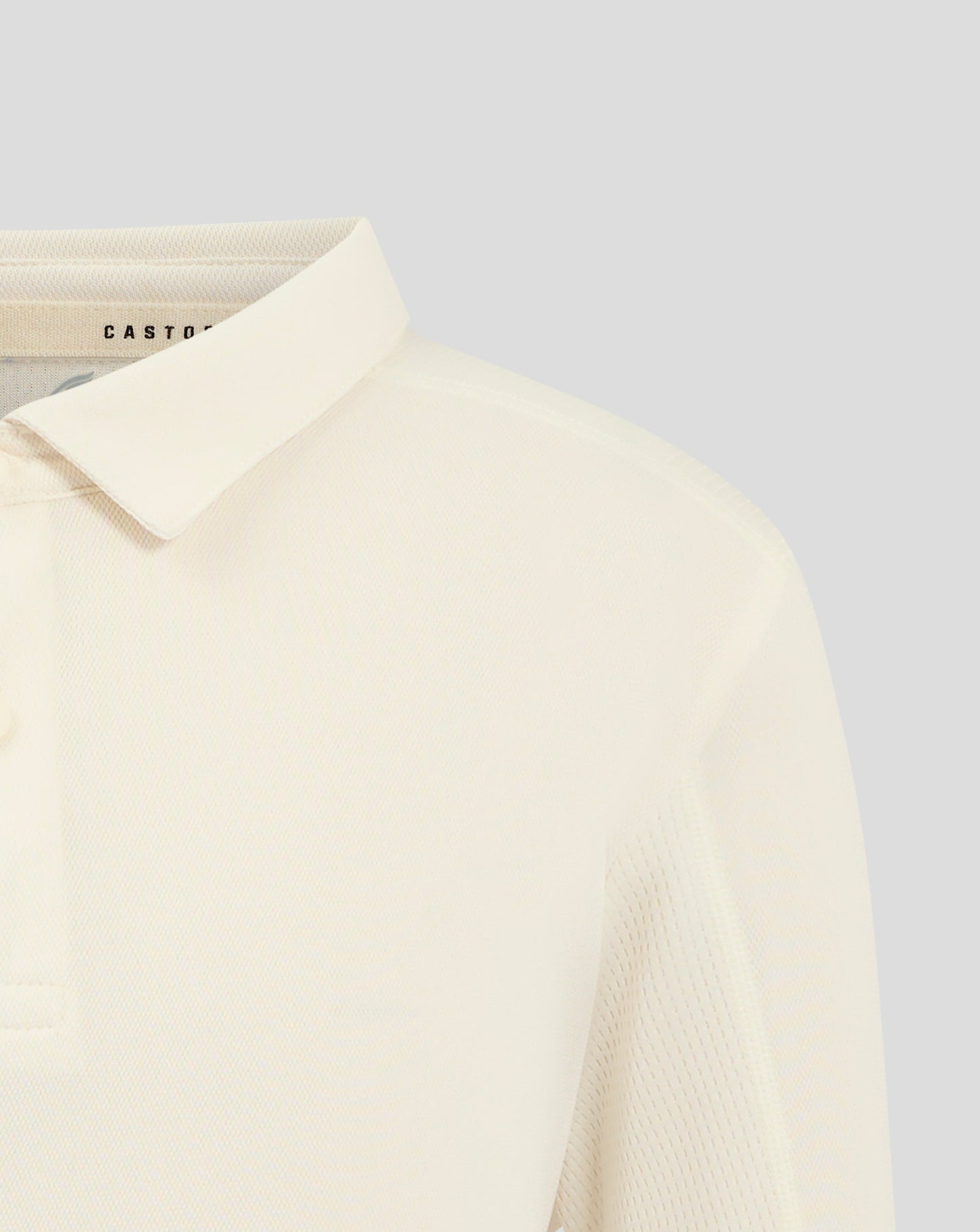Front view of Cannoli Cream junior cricket shirt with Castore crest centered on chest