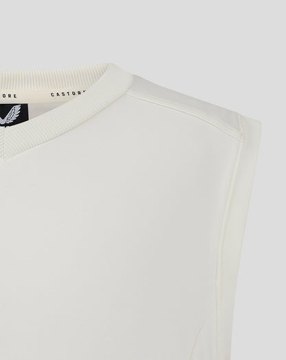 Close-up of the cream vest neckline showing ribbed V neck and Castore label inside.