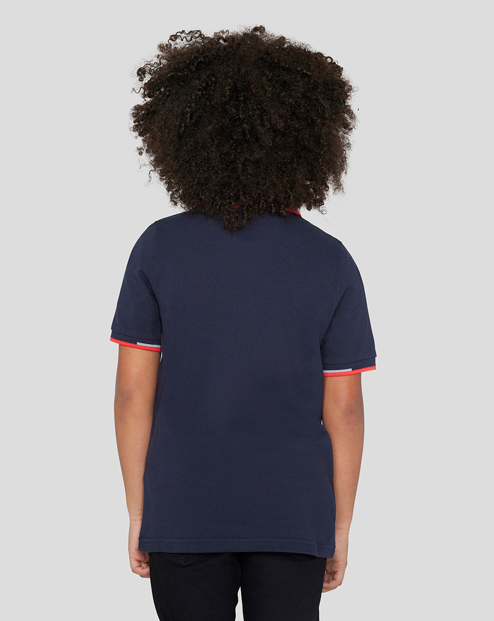 Back view of child wearing navy Night Sky Oracle Red Bull Racing Junior Core Polo with red trim at cuffs and collar