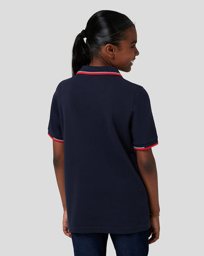 Back view of child in navy Night Sky Oracle Red Bull Racing Junior Core Polo showing red trim on collar and sleeves