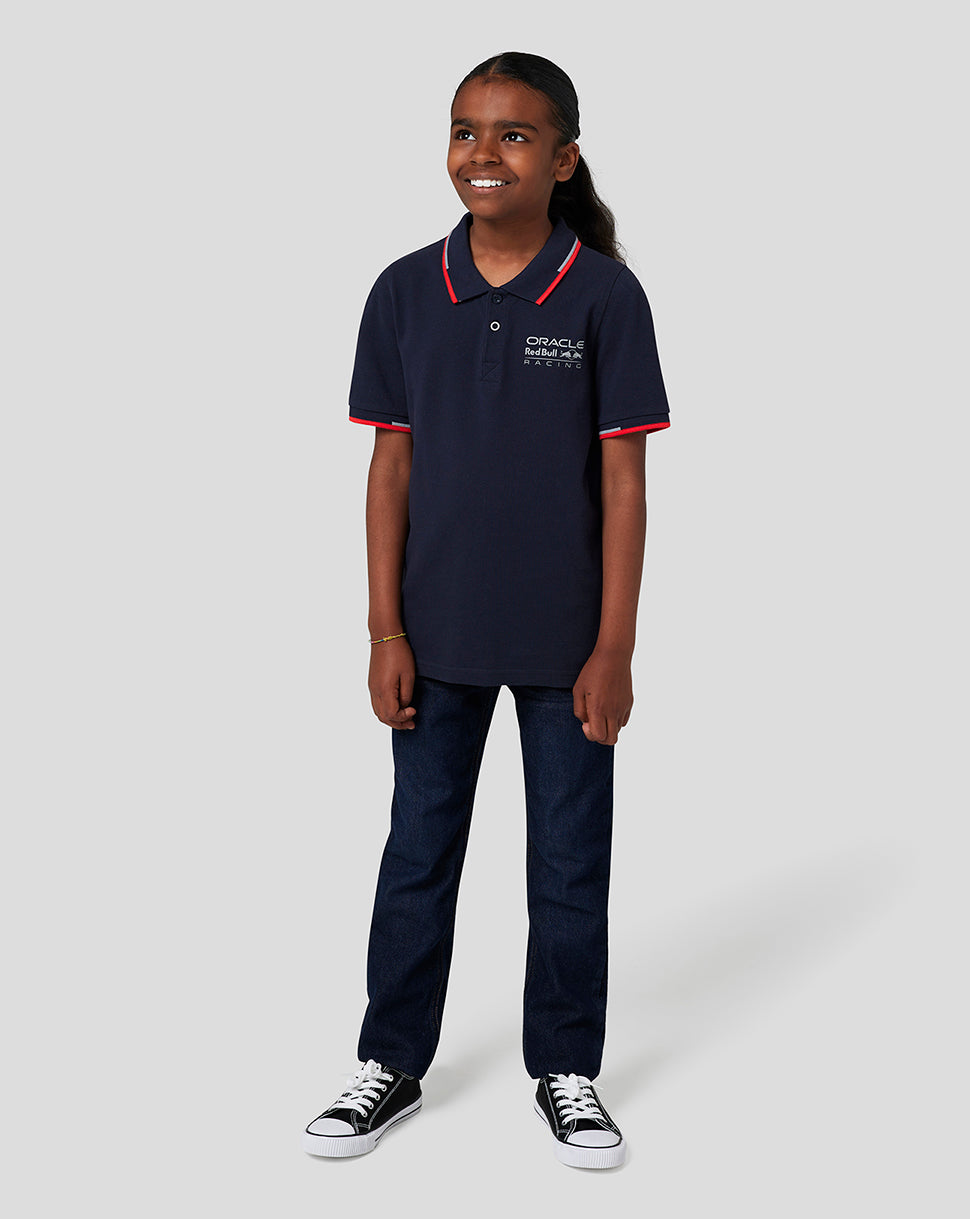 Child wearing Night Sky navy polo with red trim and Oracle Red Bull Racing logo on chest