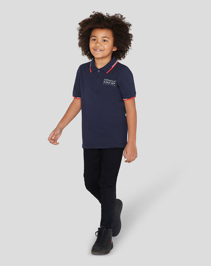 Child wearing navy Oracle Red Bull Racing Junior Core Polo with red tipping