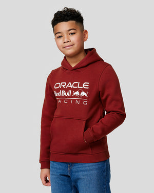 Junior boy in a burgundy hoodie with white Oracle Red Bull Racing logo across the chest.