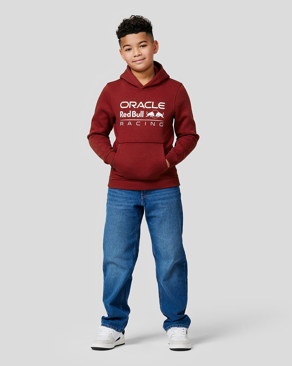 Boy wearing a maroon Oracle Red Bull Racing hoodie with white chest logo, front view.