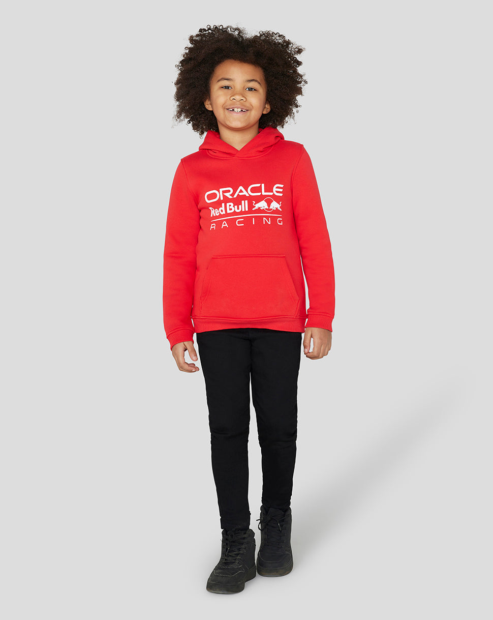 Girl in flame scarlet Core Overhead Hoodie with large Oracle Red Bull Racing logo.