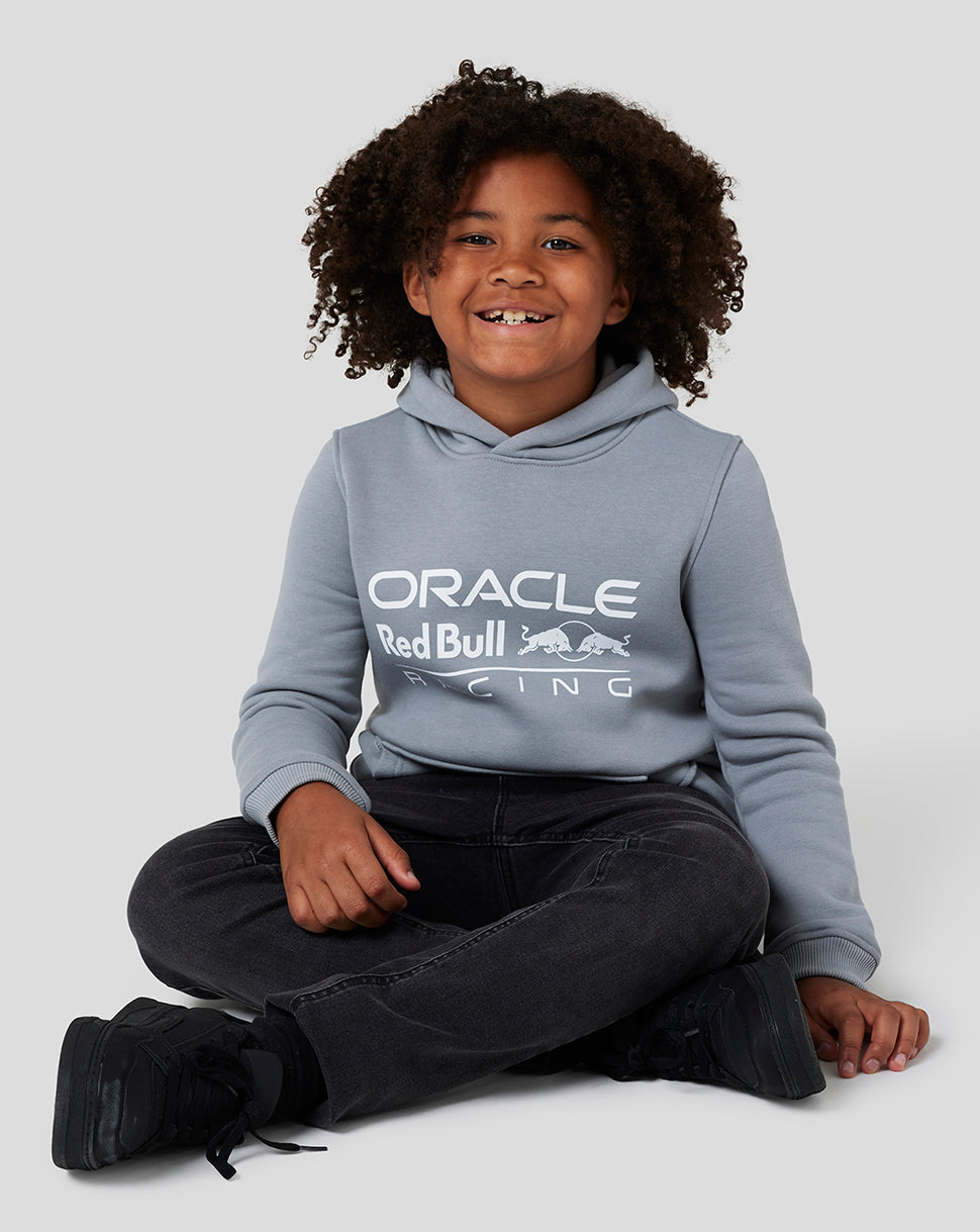 Smiling child in a grey Oracle Red Bull Racing hoodie with white logo across the chest