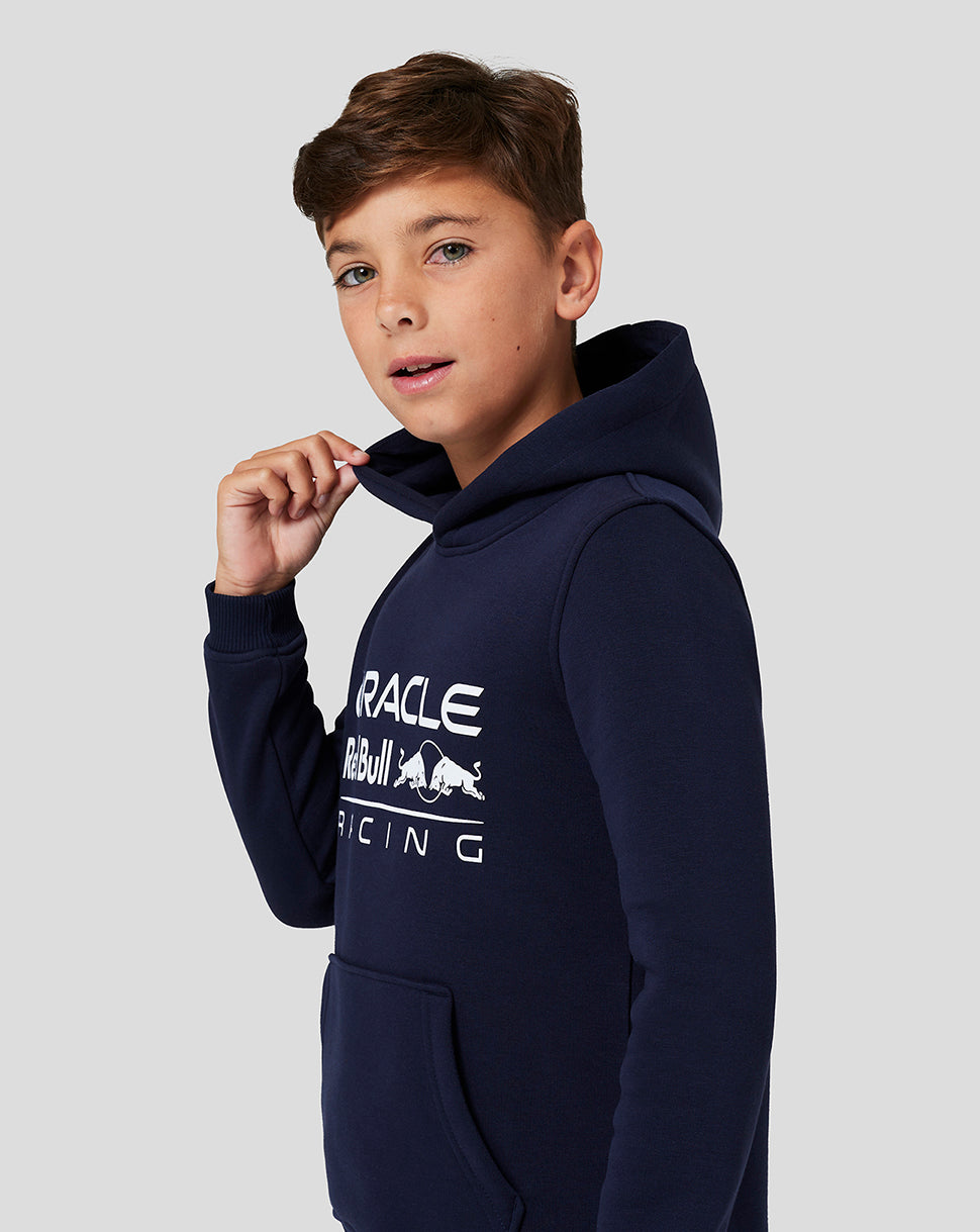 Front view of a boy in navy Core Overhead Hoodie with large Oracle Red Bull Racing logo on the chest