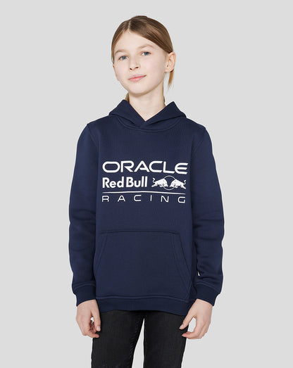 Smiling child wearing a navy Oracle Red Bull Racing hoodie with a large logo across the chest