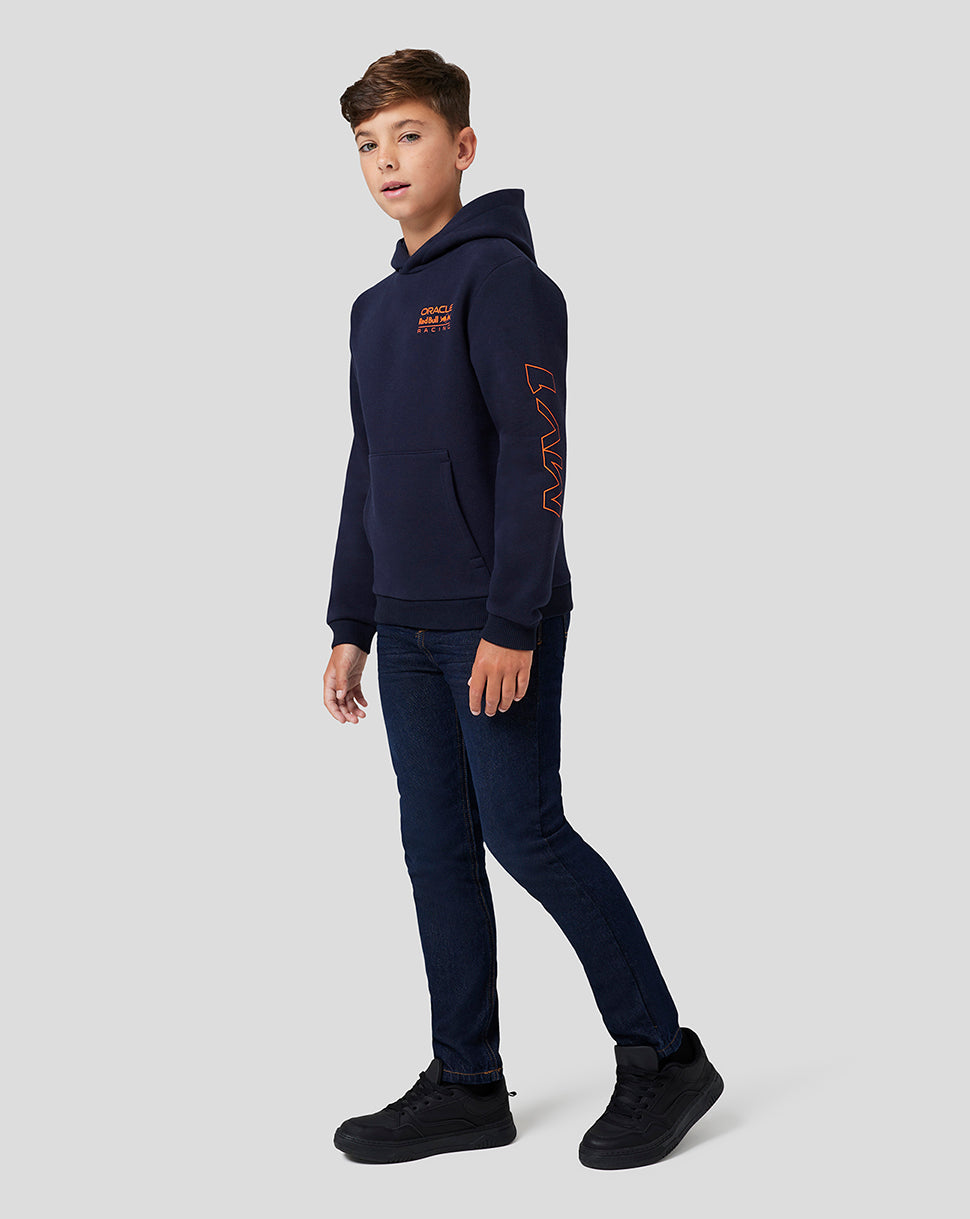 Side view of a boy in the navy night sky hoodie showing the chest logo and orange sleeve graphic