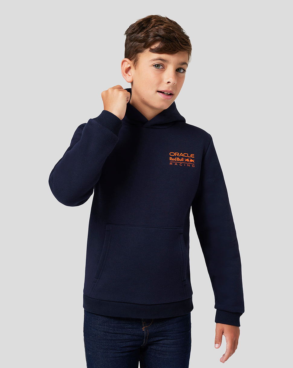 Front view of a young boy wearing a navy night sky hoodie with an orange Oracle Red Bull Racing logo on the chest