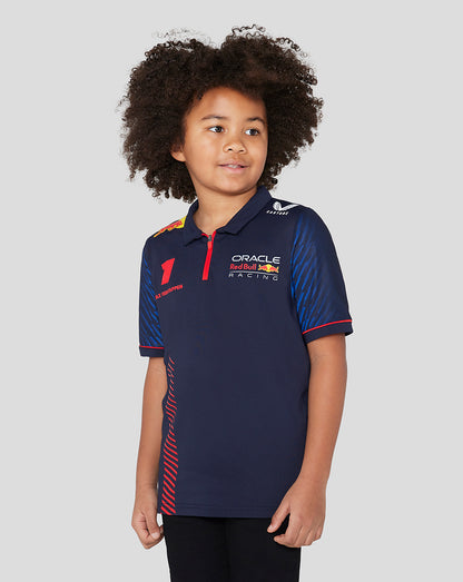 Front view of a young boy wearing a navy Oracle Red Bull Racing junior polo with Verstappen name and number 1