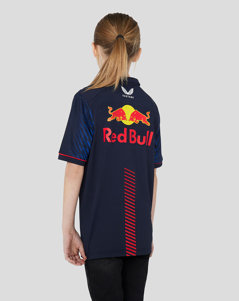 Back view of a young model wearing a night sky navy Red Bull Racing polo with a large logo on the back.