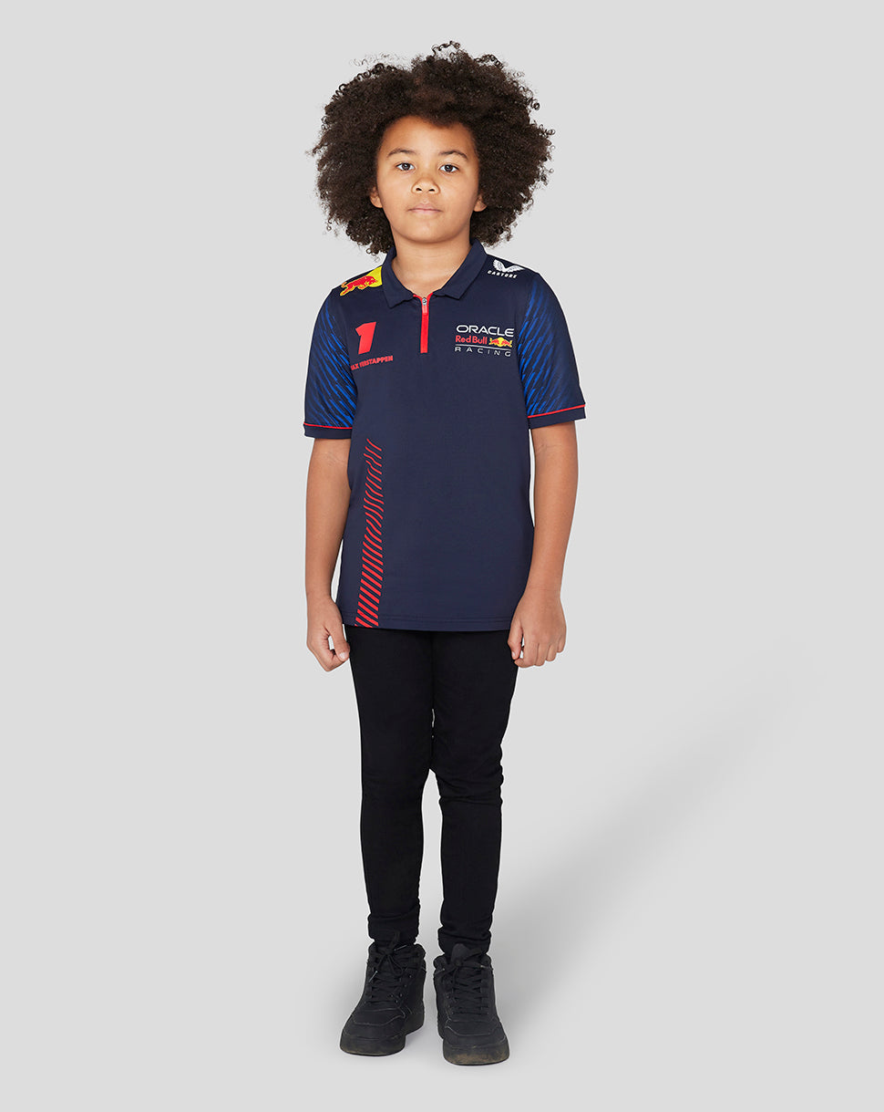 Front view of a smiling young girl wearing a navy Oracle Red Bull Racing polo with the number 1 and sponsor logos on the chest.