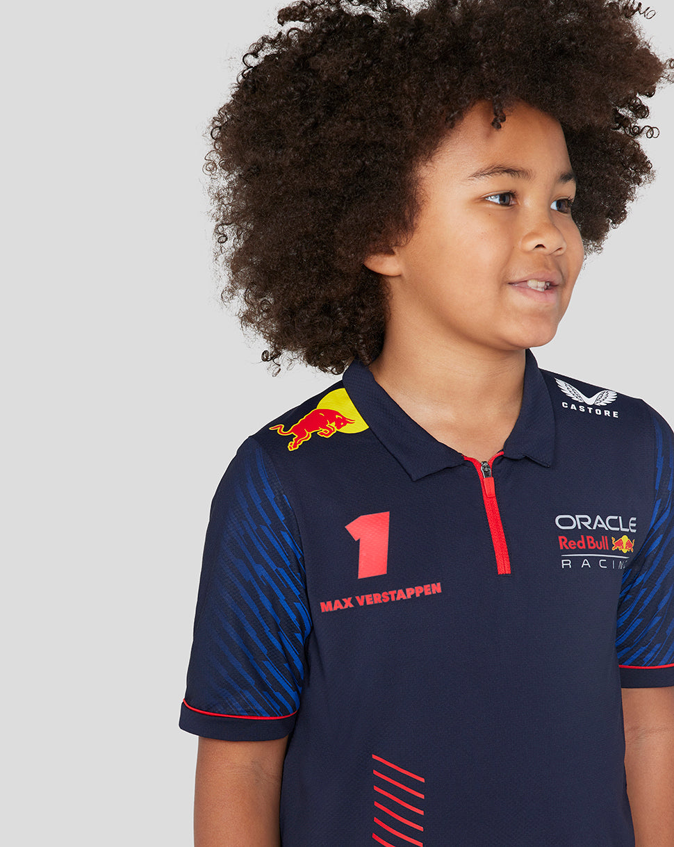 Close up of a child in a navy Oracle Red Bull Racing polo showcasing racing logos on the chest