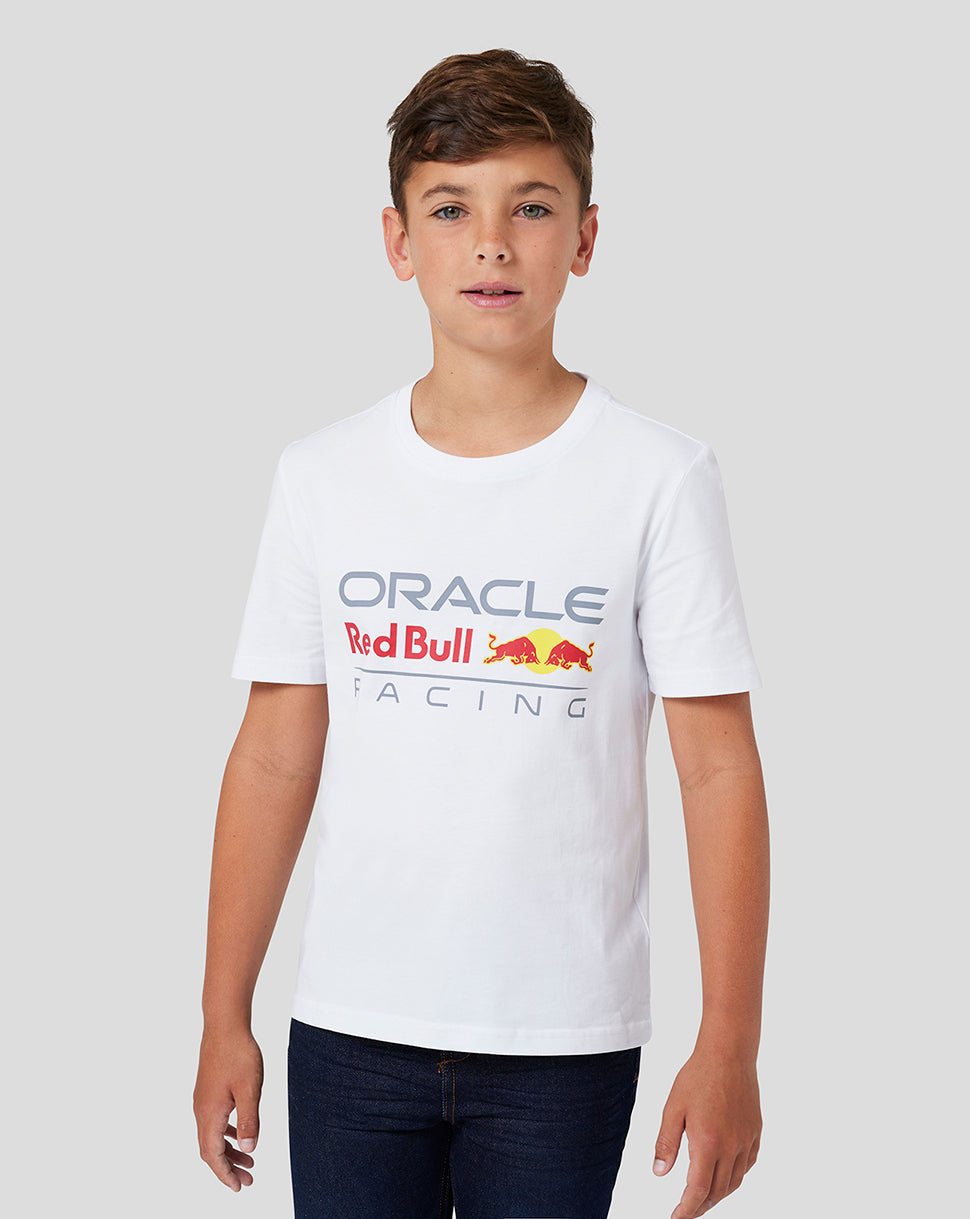Smiling boy wearing a white Oracle Red Bull Racing Front Logo T Shirt with a full color logo on the chest