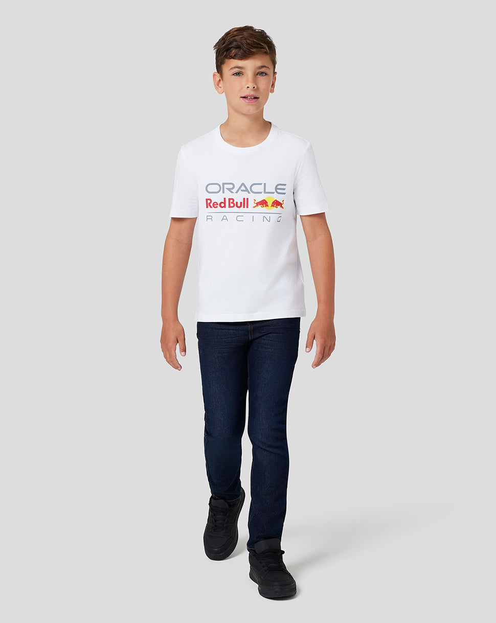 Boy in white Oracle Red Bull Racing Junior Large Front Logo T shirt with the colorful logo on the chest