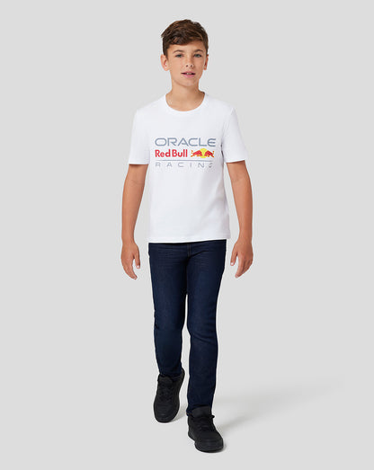 Boy in white Oracle Red Bull Racing Junior Large Front Logo T shirt with the colorful logo on the chest