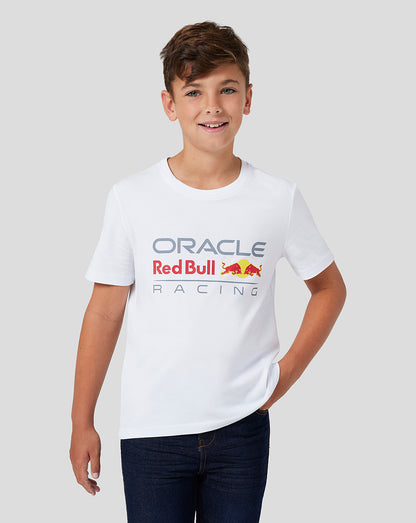 Boy in white Oracle Red Bull Racing Junior Large Front Logo T shirt with the colorful logo on the chest