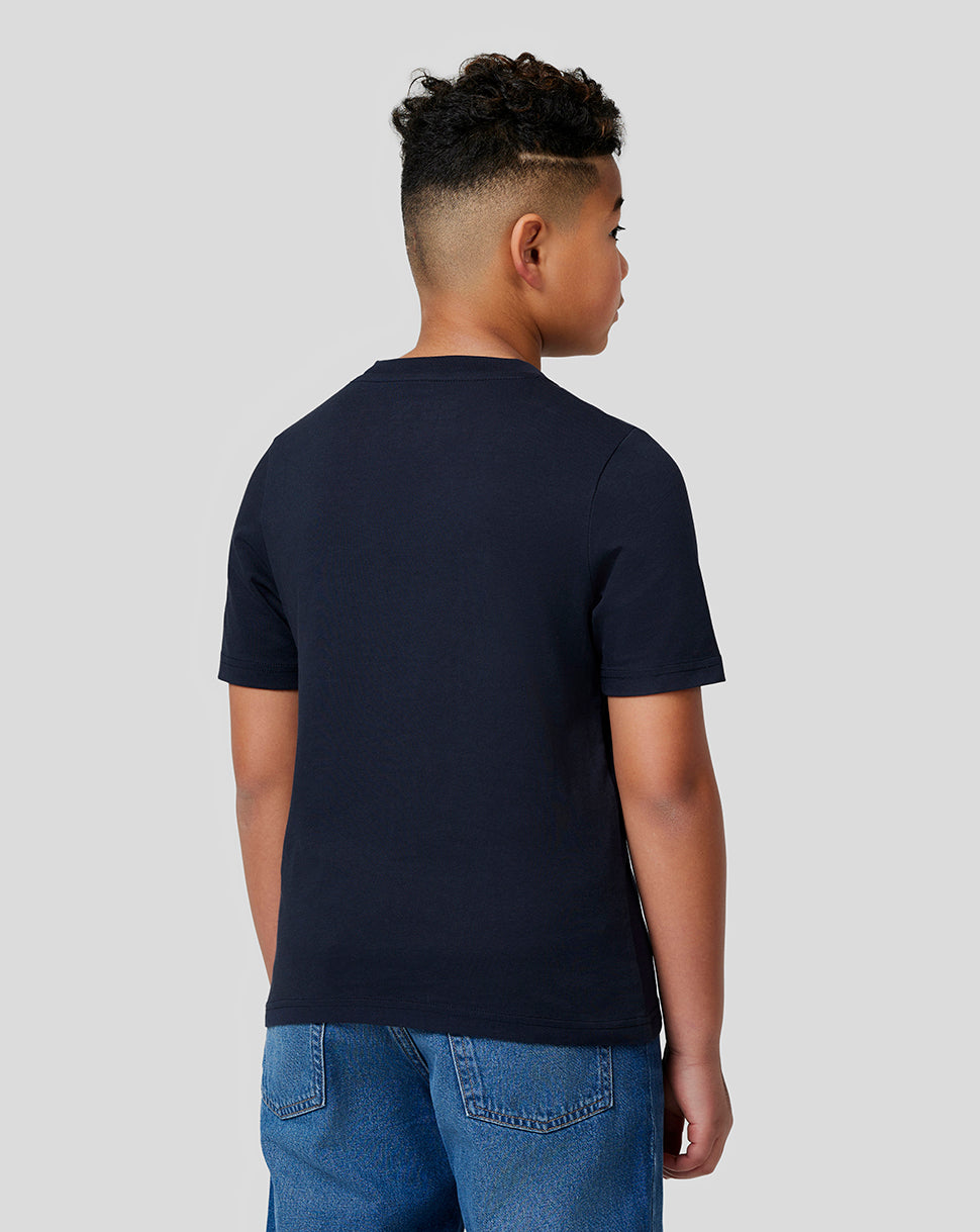 Back view of a young boy wearing a navy Oracle Red Bull Racing t shirt.