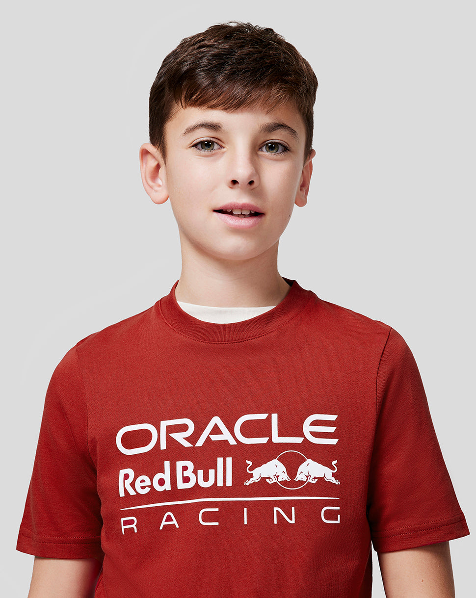 Front view of a child wearing a red Oracle Red Bull Racing juniors tee with a white logo on the chest