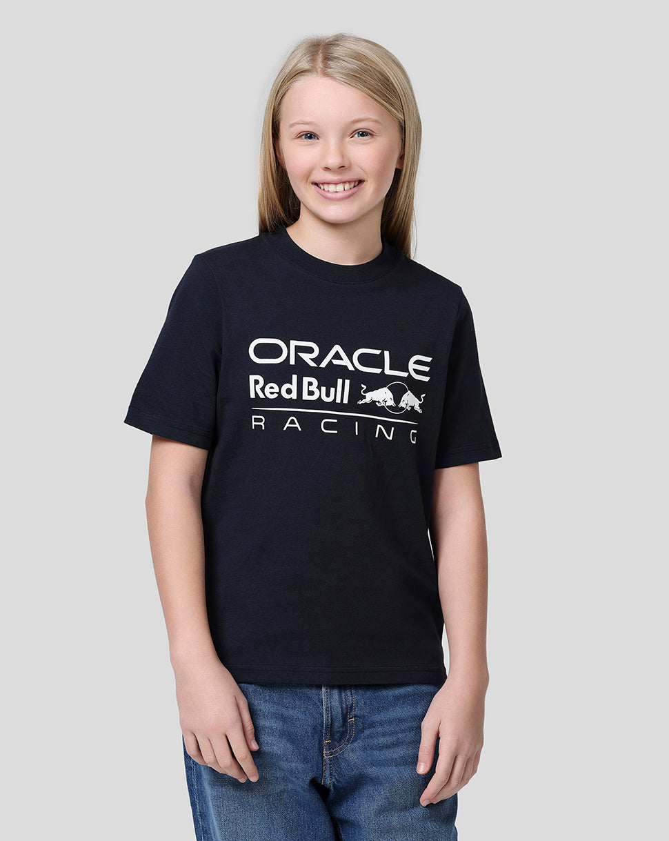 Girl with blonde hair wearing a navy Oracle Red Bull Racing large front logo tee
