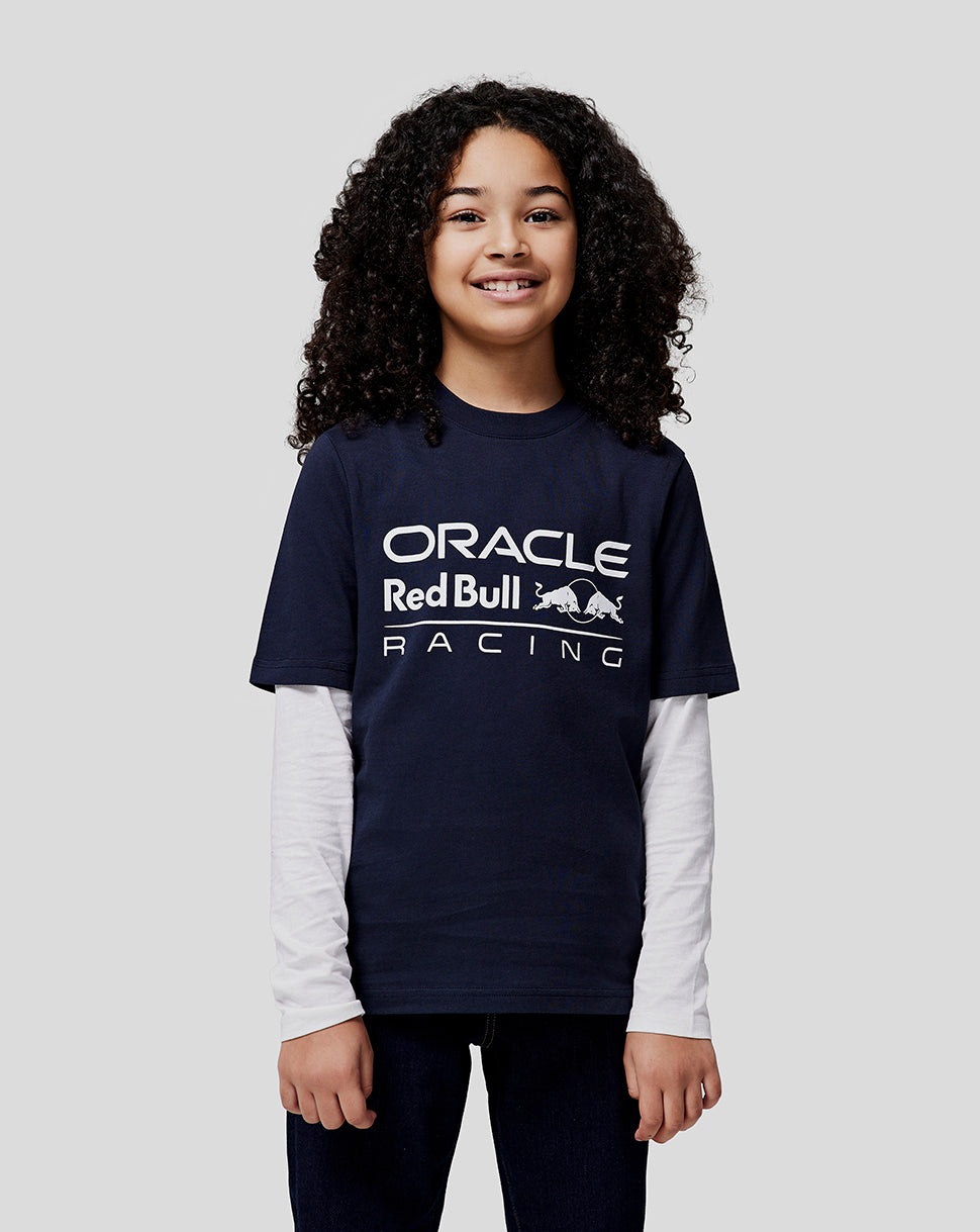 Smiling girl with curly dark hair wearing a navy Oracle Red Bull Racing large front logo tee